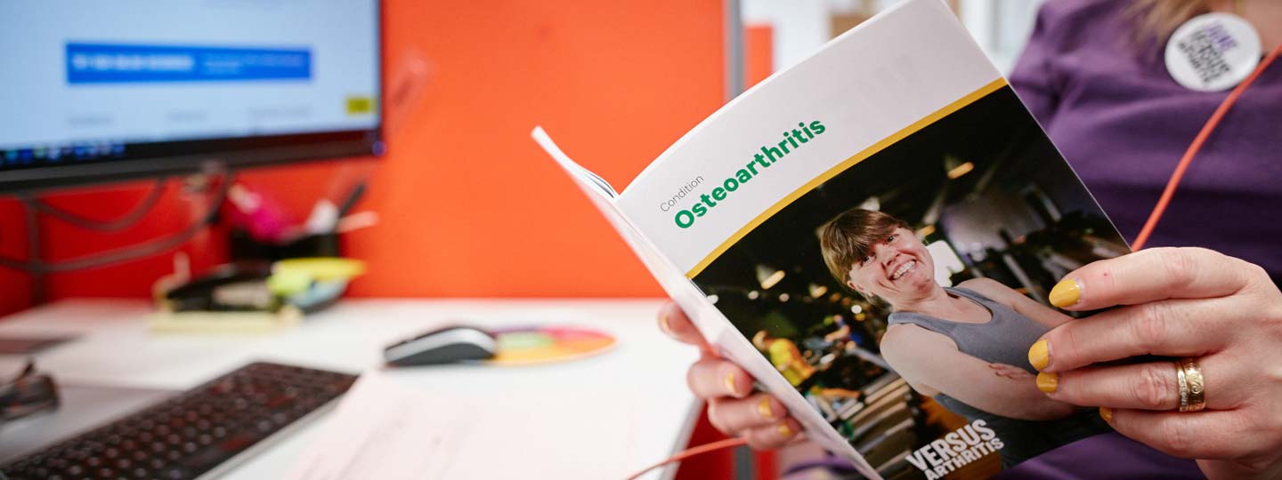 A women reading a Osteoarthritis information booklet