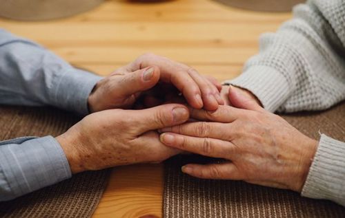 Two hands holding each other