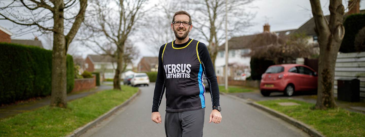 Ian standing outside wearing running vest