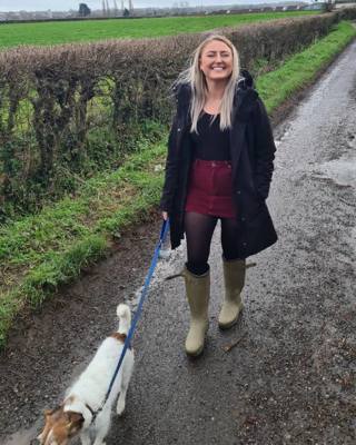 Smiling Rachel walking dog