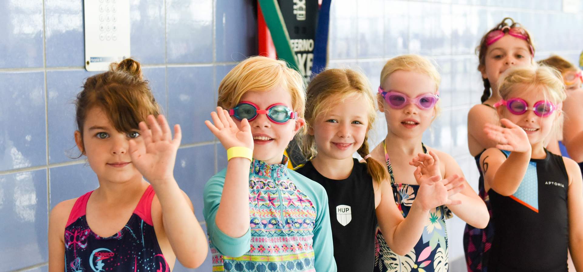 Kids triathlon challengers waving