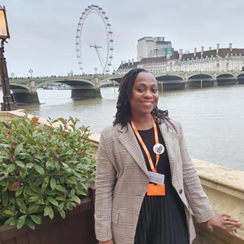 Arthritis UK Supporter Ayo standing by the Thames