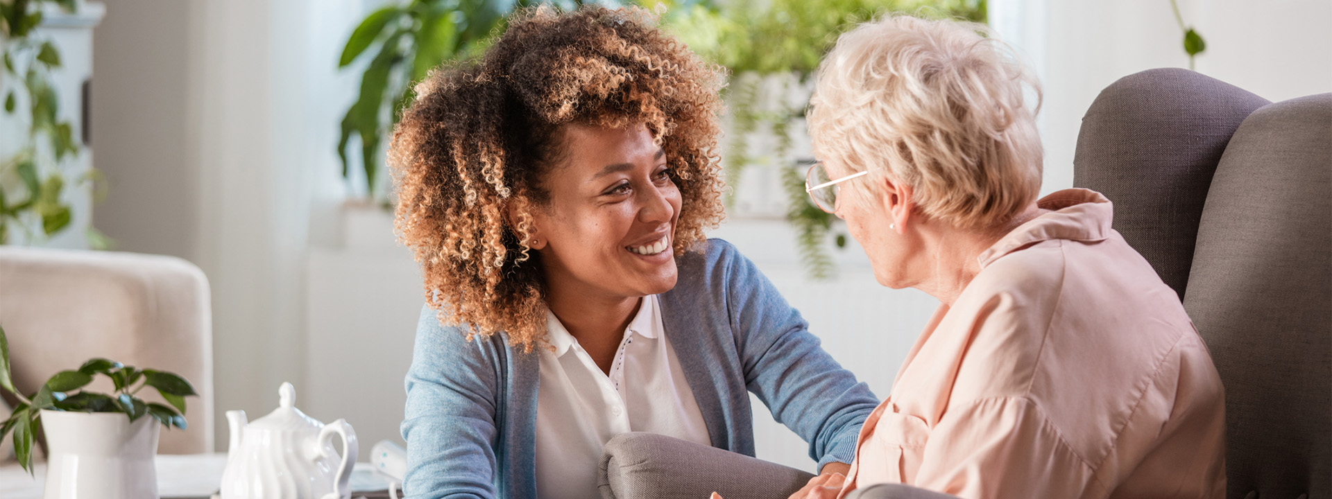 Arthritis health care professional talking with elderly woman patient