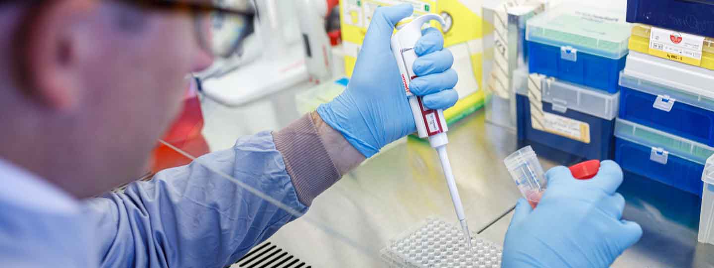 Arthritis UK researcher with a pipette