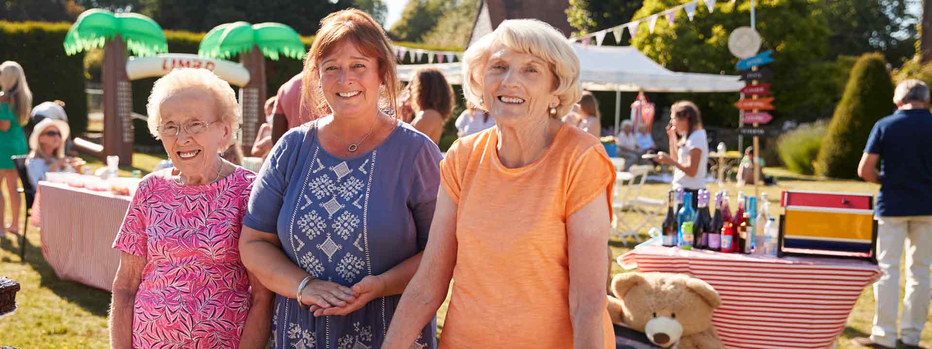 Three smiling ladies of different ages at a local fair