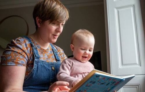 Sarah reading to her child