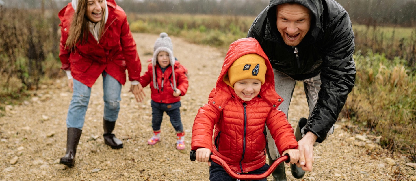 Family And Young Person With JIA Riding Bike
