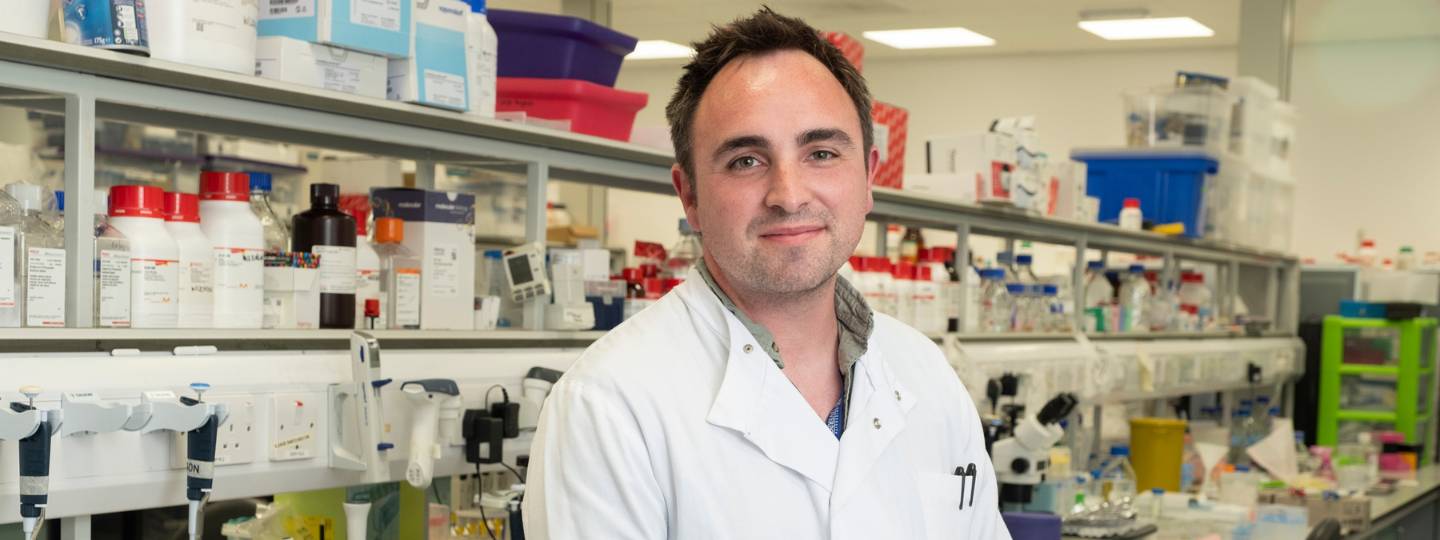 Researcher Dr David Wilkinson standing in a laboratory